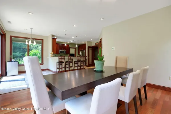 a dining room with furniture and wooden floor