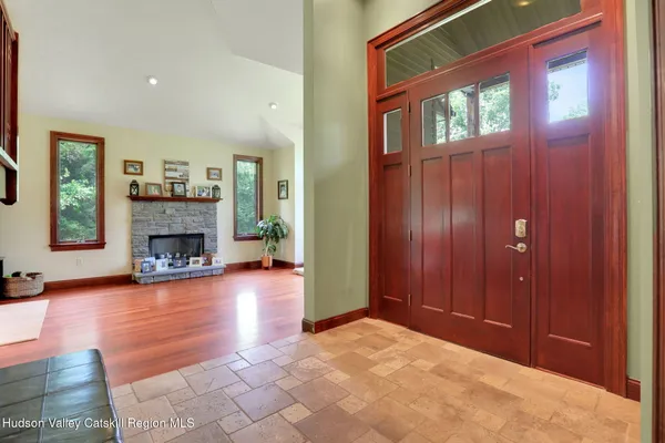 a view of a livingroom with a fireplace and window