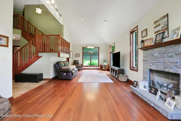 a living room with furniture fireplace and flat screen tv