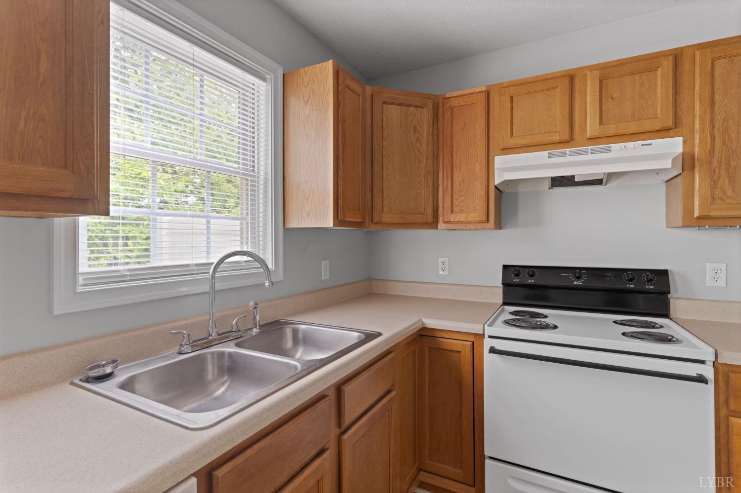 1083 Blane Drive Forest, VA 24551 - Photo 11 of 19 a kitchen with a sink cabinets and window