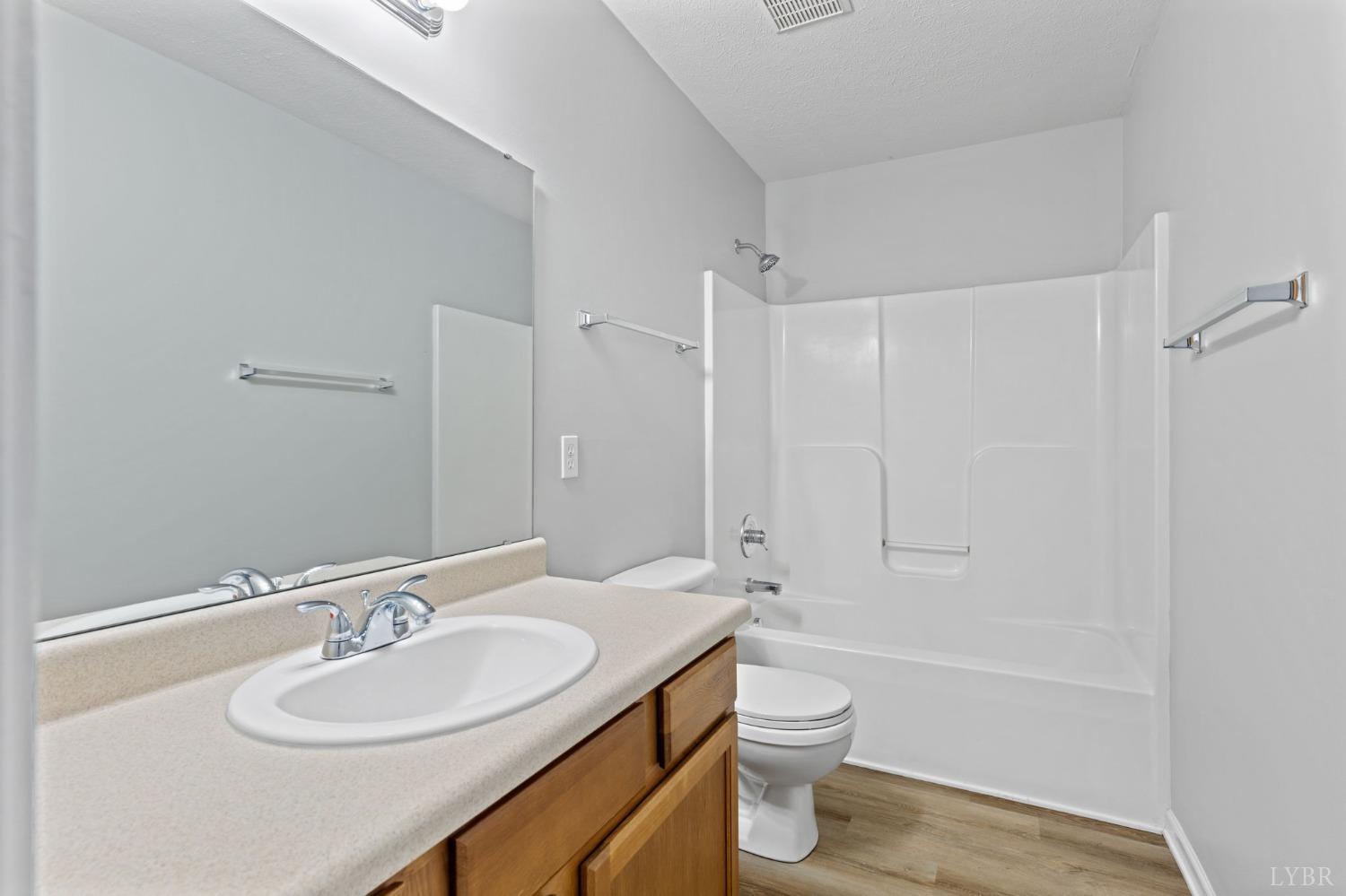 1083 Blane Drive Forest, VA 24551 - Photo 15 of 19 a bathroom with a sink a toilet and shower