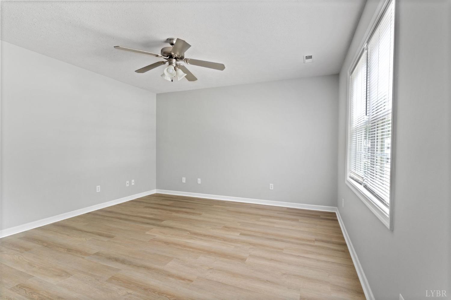 1083 Blane Drive Forest, VA 24551 - Photo 4 of 19 wooden floor in an empty room with a window