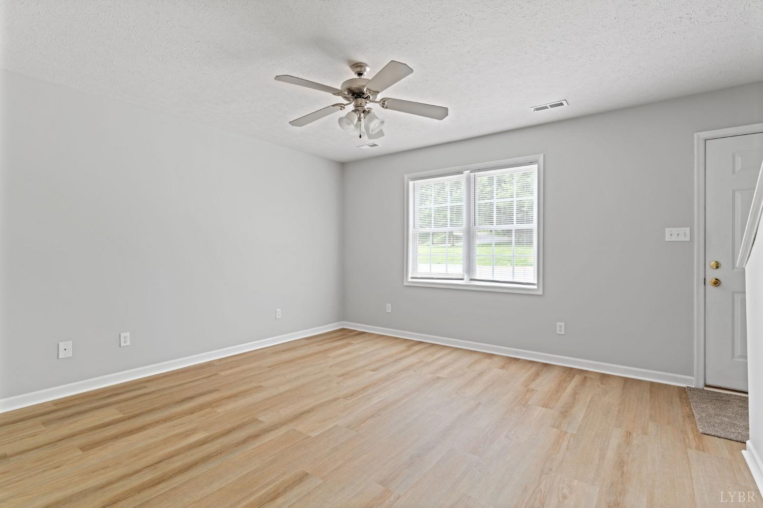 1083 Blane Drive Forest, VA 24551 - Photo 5 of 19 a view of an empty room with wooden floor and a window