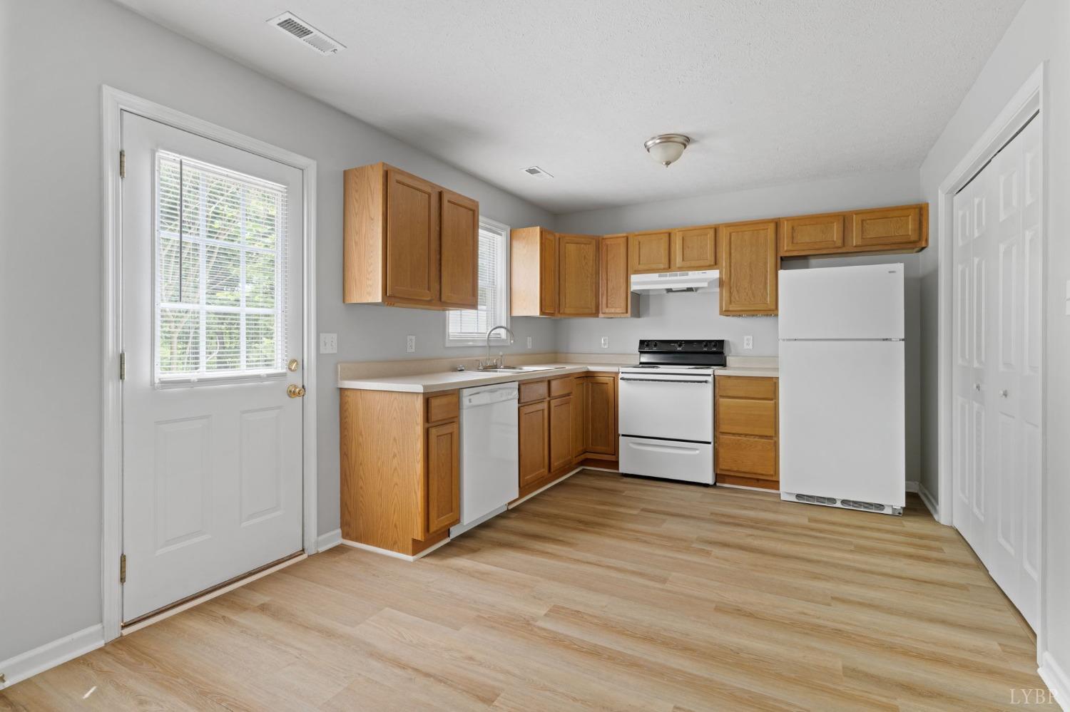 1083 Blane Drive Forest, VA 24551 - Photo 9 of 19 a kitchen with granite countertop wooden floors and white stainless steel appliances