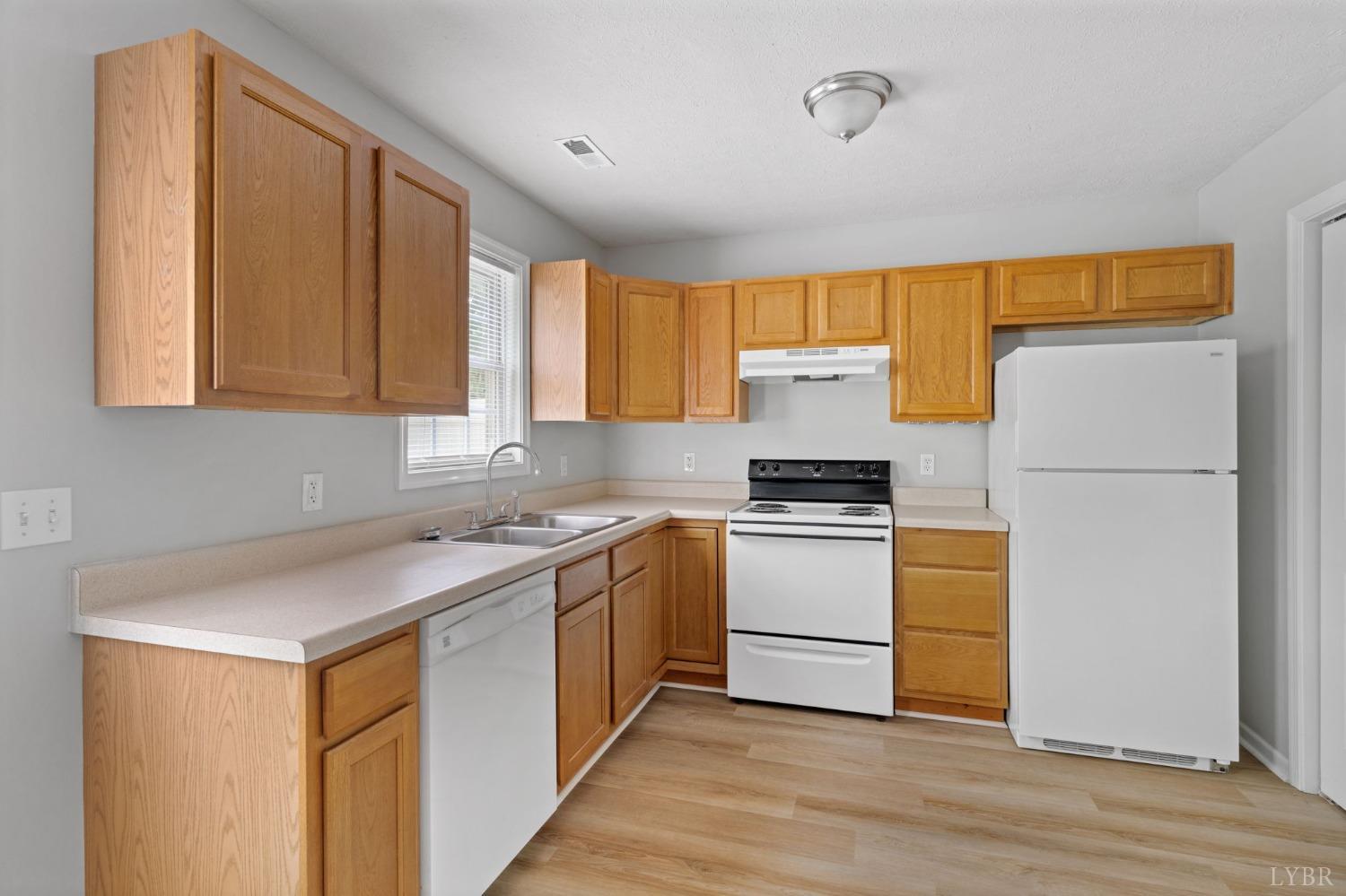 1083 Blane Drive Forest, VA 24551 - Photo 10 of 19 a kitchen with a white stove top oven and refrigerator