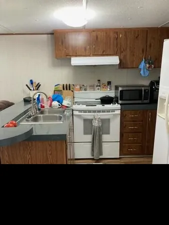 a kitchen with a stove and cabinets