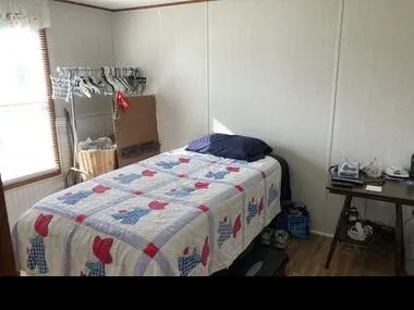 a bedroom with a bed and a table in it