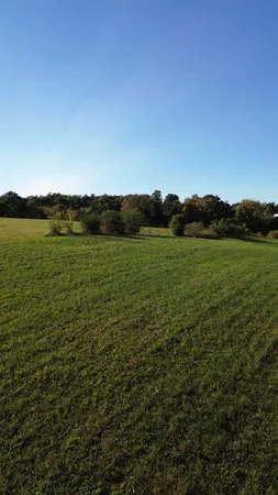 a view of grassy field with mountain
