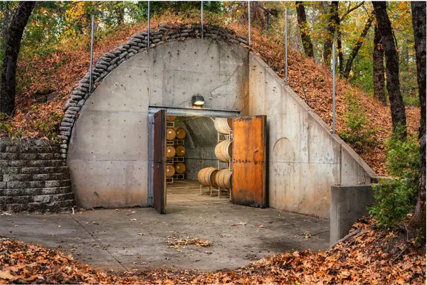 a view of an empty room with cabinet and a window