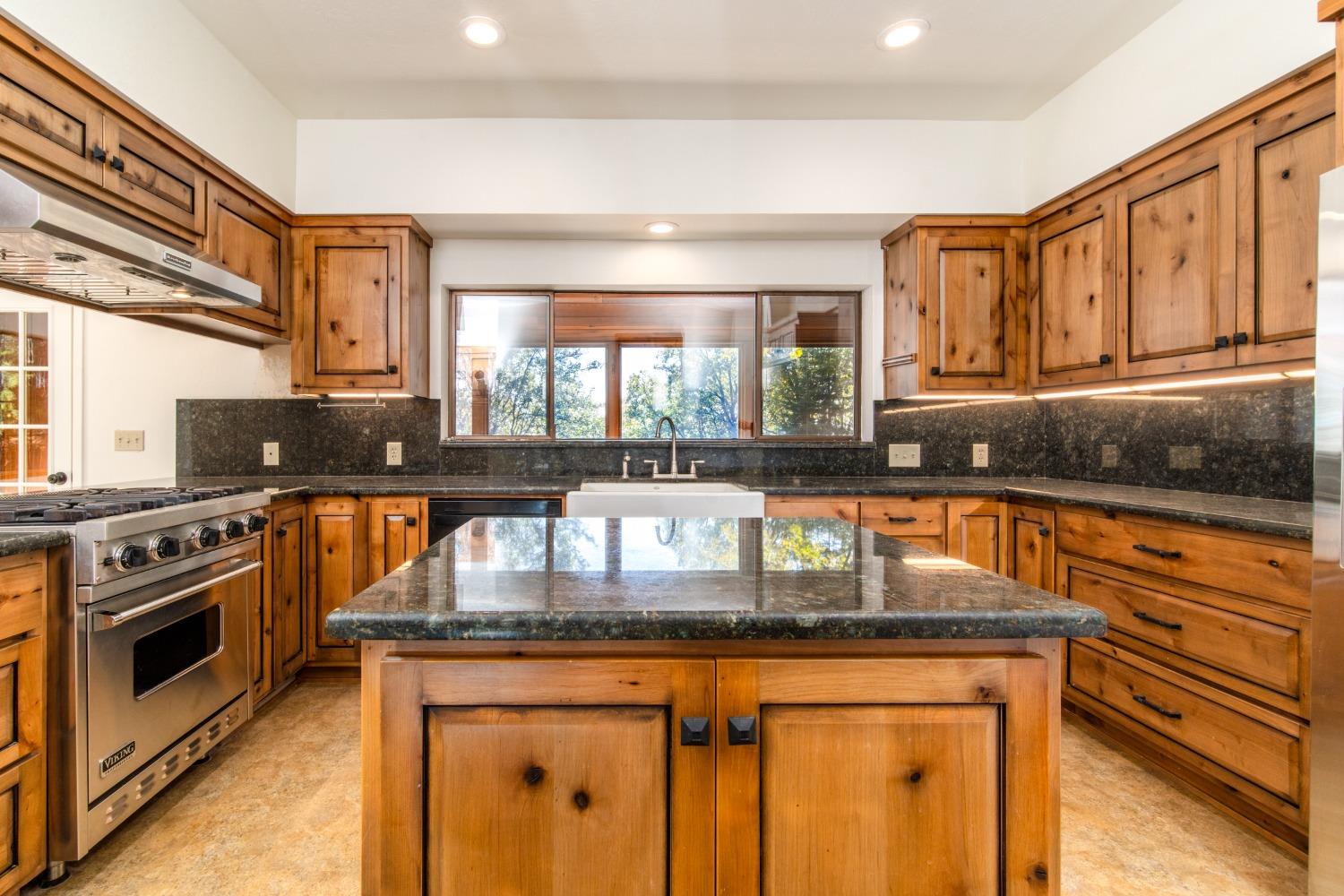 3961 7 Ridges Road Camino, CA 95709 - Photo 41 of 93 a kitchen with granite countertop a stove and a sink