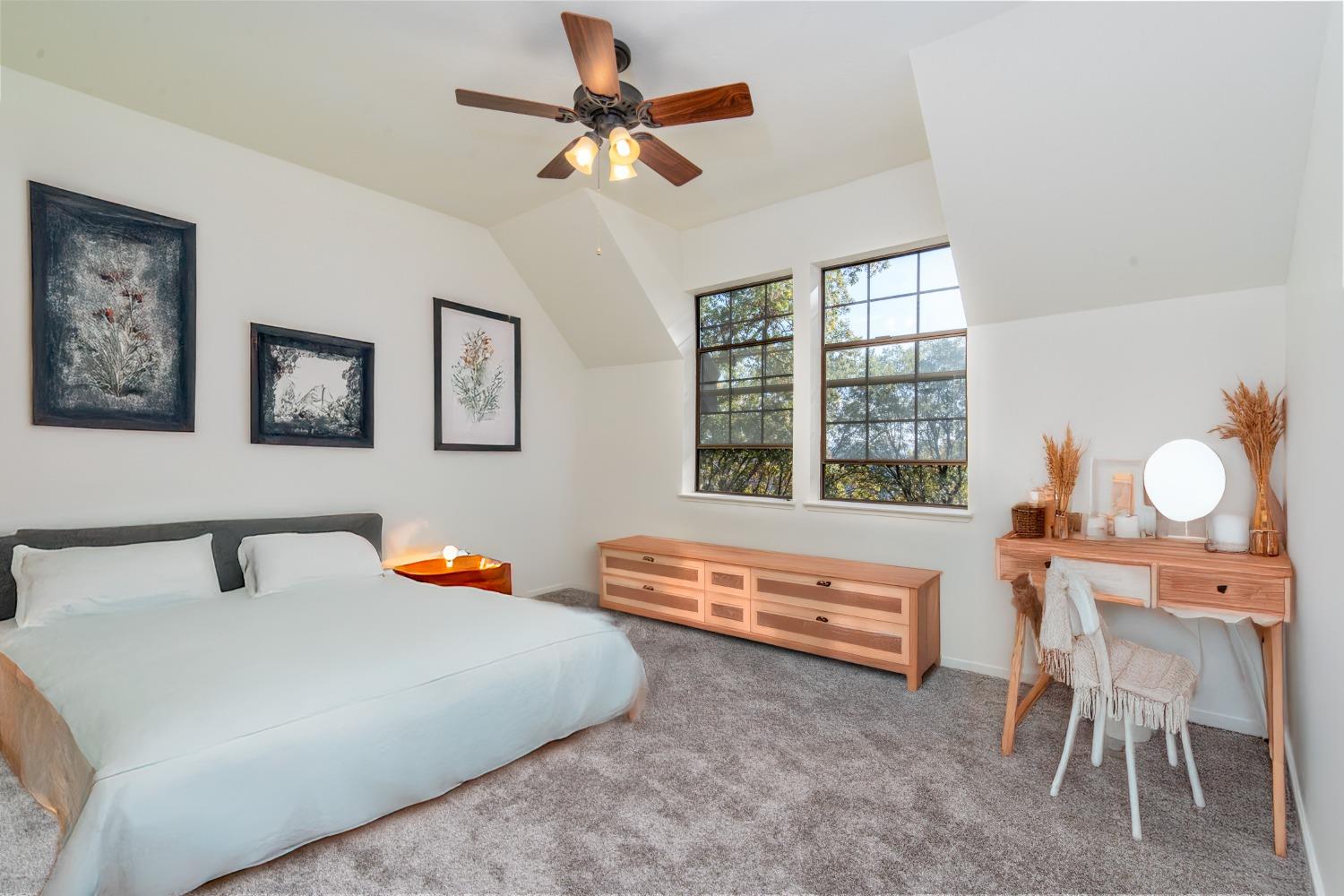 3961 7 Ridges Road Camino, CA 95709 - Photo 68 of 93 a bedroom with a bed a chair and a chandelier