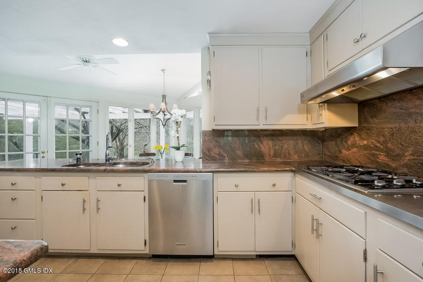 194 Bedford Road Greenwich, CT 06831 - Photo 13 of 44 a kitchen with white cabinets and appliances