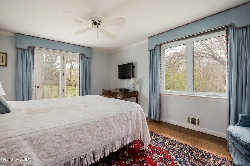 194 Bedford Road Greenwich, CT 06831 - Photo 16 of 44 a bedroom with a bed and a large window