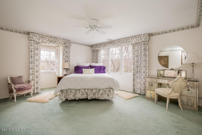 194 Bedford Road Greenwich, CT 06831 - Photo 19 of 44 a spacious bedroom with a bed and a chair