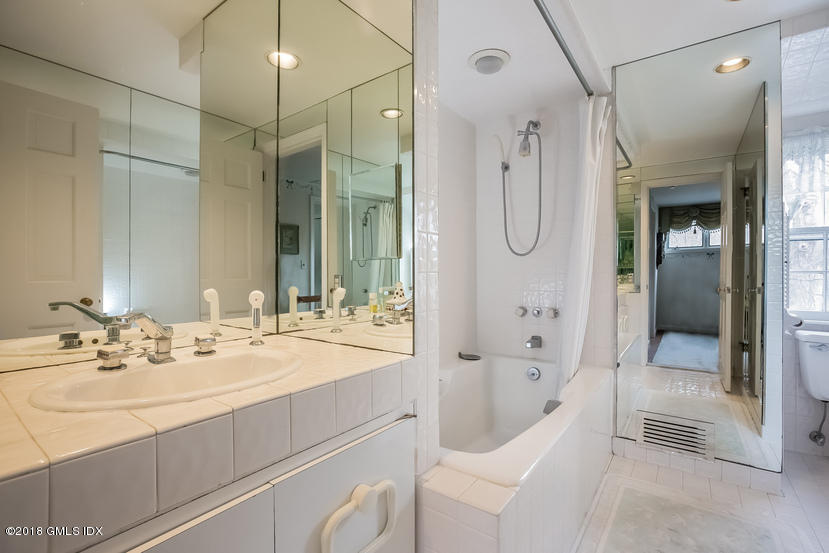 194 Bedford Road Greenwich, CT 06831 - Photo 20 of 44 a bathroom with a bathtub shower sink and mirror