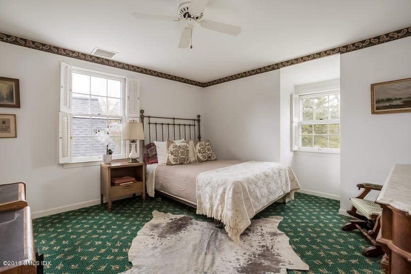 194 Bedford Road Greenwich, CT 06831 - Photo 21 of 44 a bedroom with a bed and a window