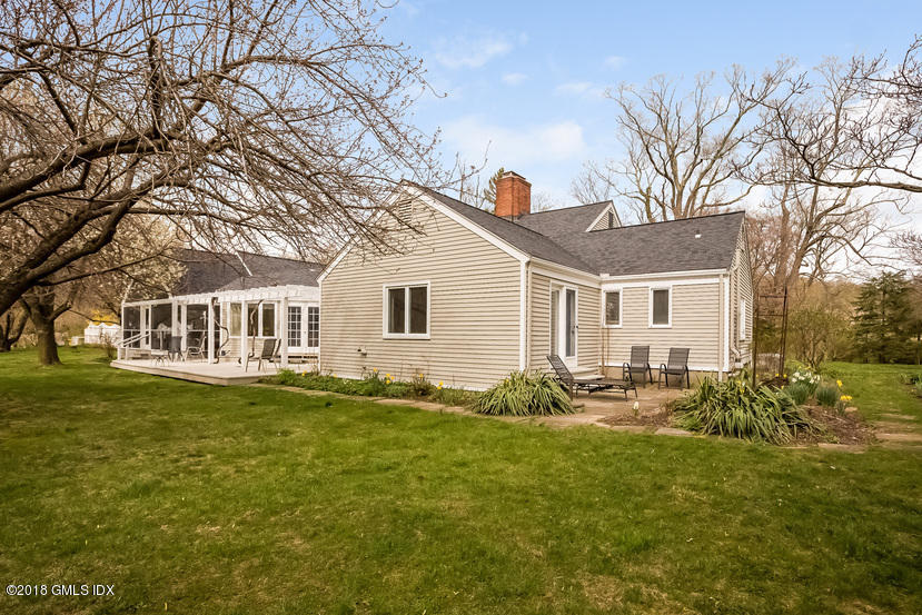 194 Bedford Road Greenwich, CT 06831 - Photo 22 of 44 a front view of a house with a garden