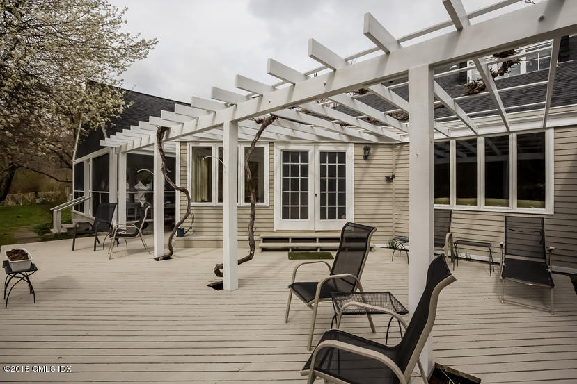 194 Bedford Road Greenwich, CT 06831 - Photo 23 of 44 a view of a patio with table and chairs with wooden floor and fence