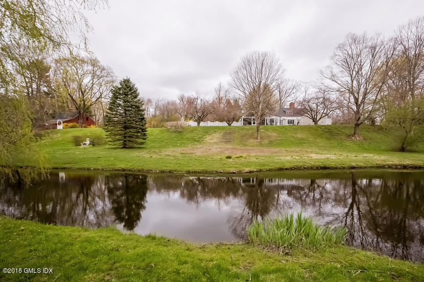 194 Bedford Road Greenwich, CT 06831 - Photo 30 of 44 a view of a lake with a yard and large trees