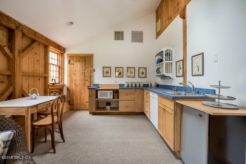 194 Bedford Road Greenwich, CT 06831 - Photo 37 of 44 a large white kitchen with a table and chairs
