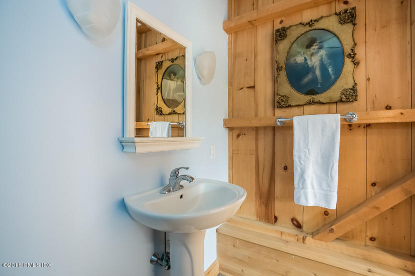 194 Bedford Road Greenwich, CT 06831 - Photo 42 of 44 a bathroom with a sink a mirror and a toilet