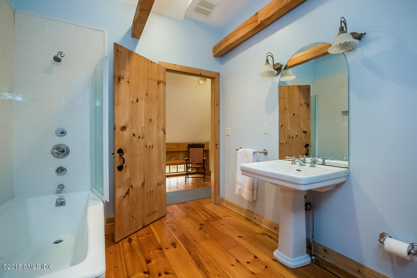 194 Bedford Road Greenwich, CT 06831 - Photo 43 of 44 a bathroom with a sink a mirror and a shower