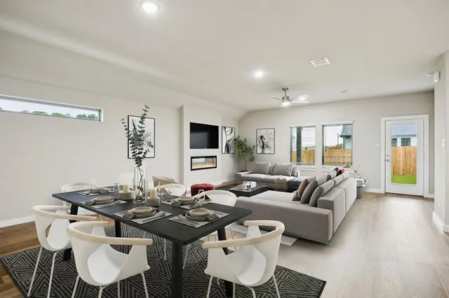 a living room with furniture a wooden floor and a table