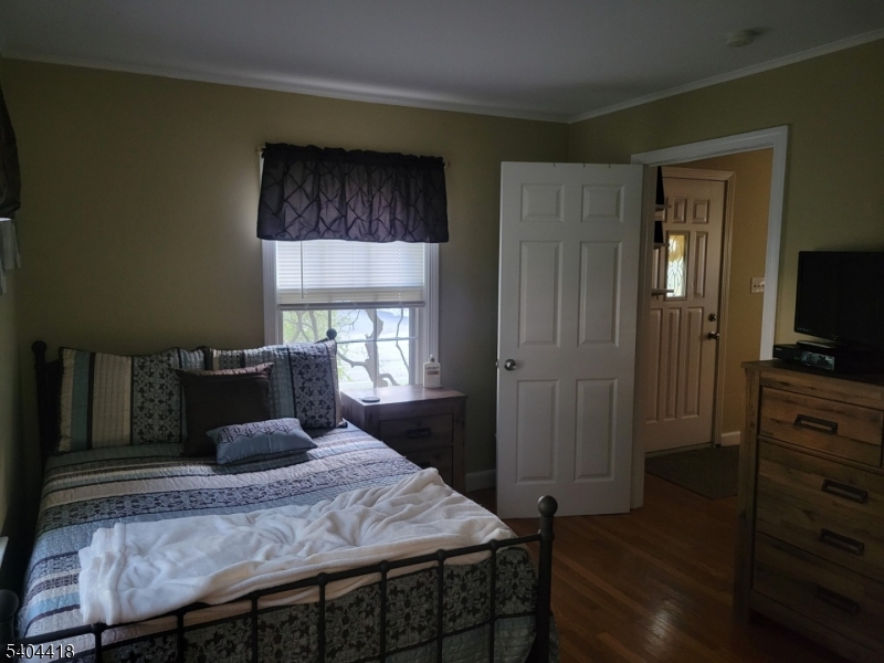 8 Randolph Avenue Hopatcong, NJ 07843 - Photo 13 of 30 a bedroom with a bed and wooden floor