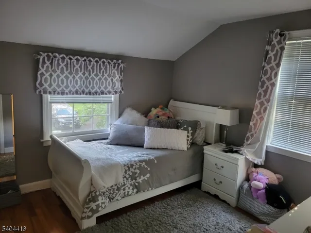 a bedroom with a bed and a mirror