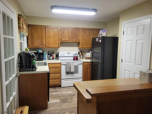 a kitchen with stainless steel appliances a refrigerator sink and cabinets