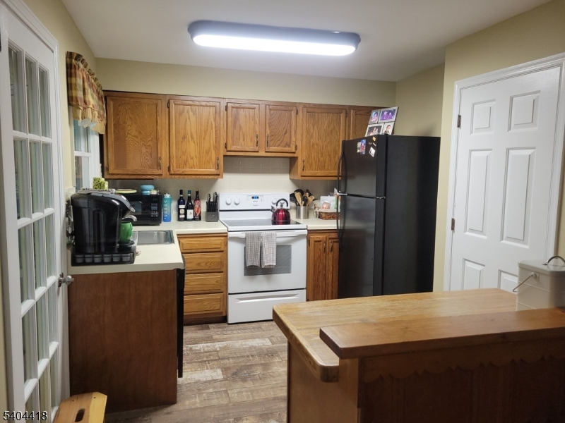 8 Randolph Avenue Hopatcong, NJ 07843 - Photo 8 of 30 a kitchen with stainless steel appliances a refrigerator sink and cabinets