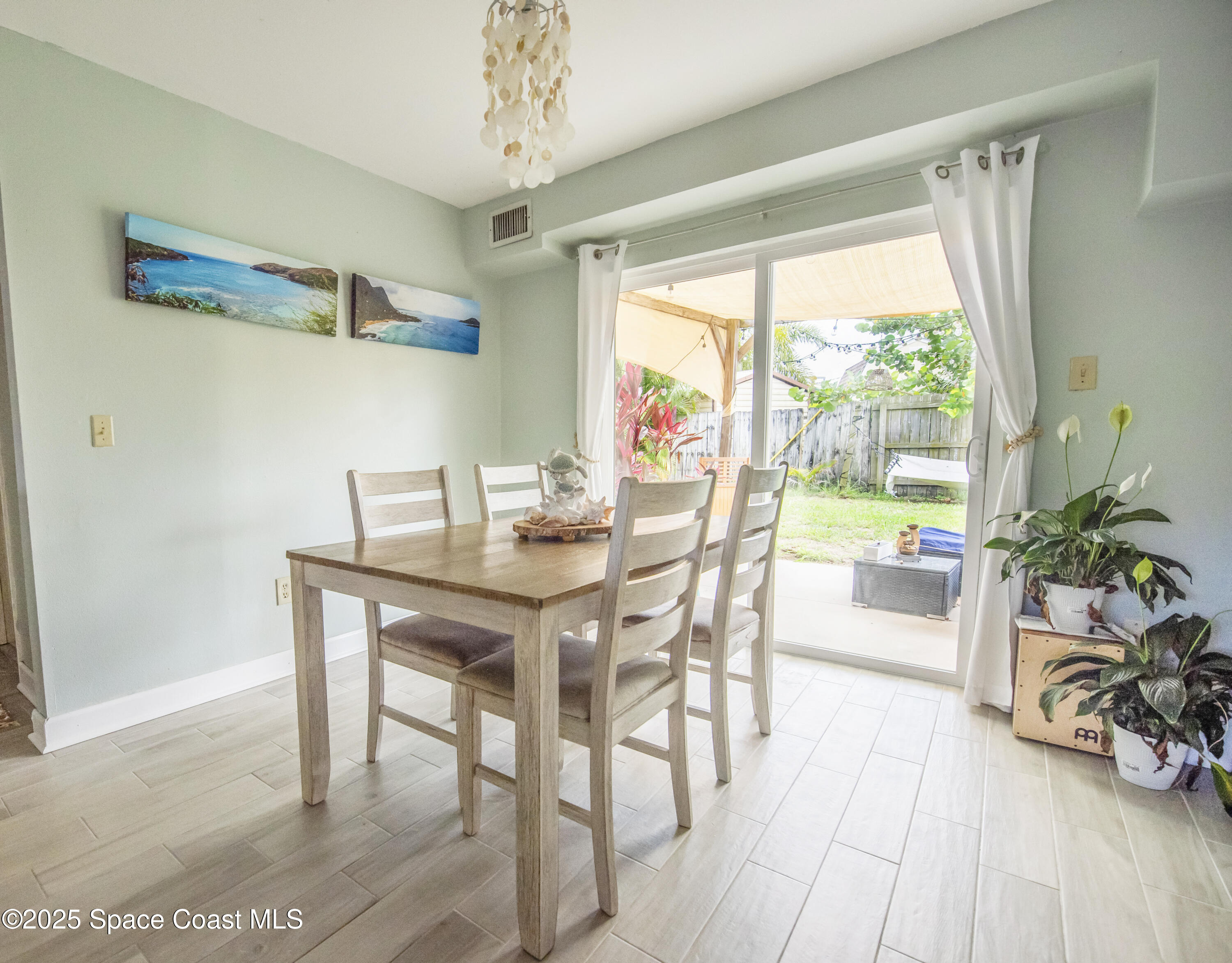 142 Atlantic Avenue Indialantic, FL 32903 - Photo 12 of 28 a view of a dining room with furniture window and wooden floor