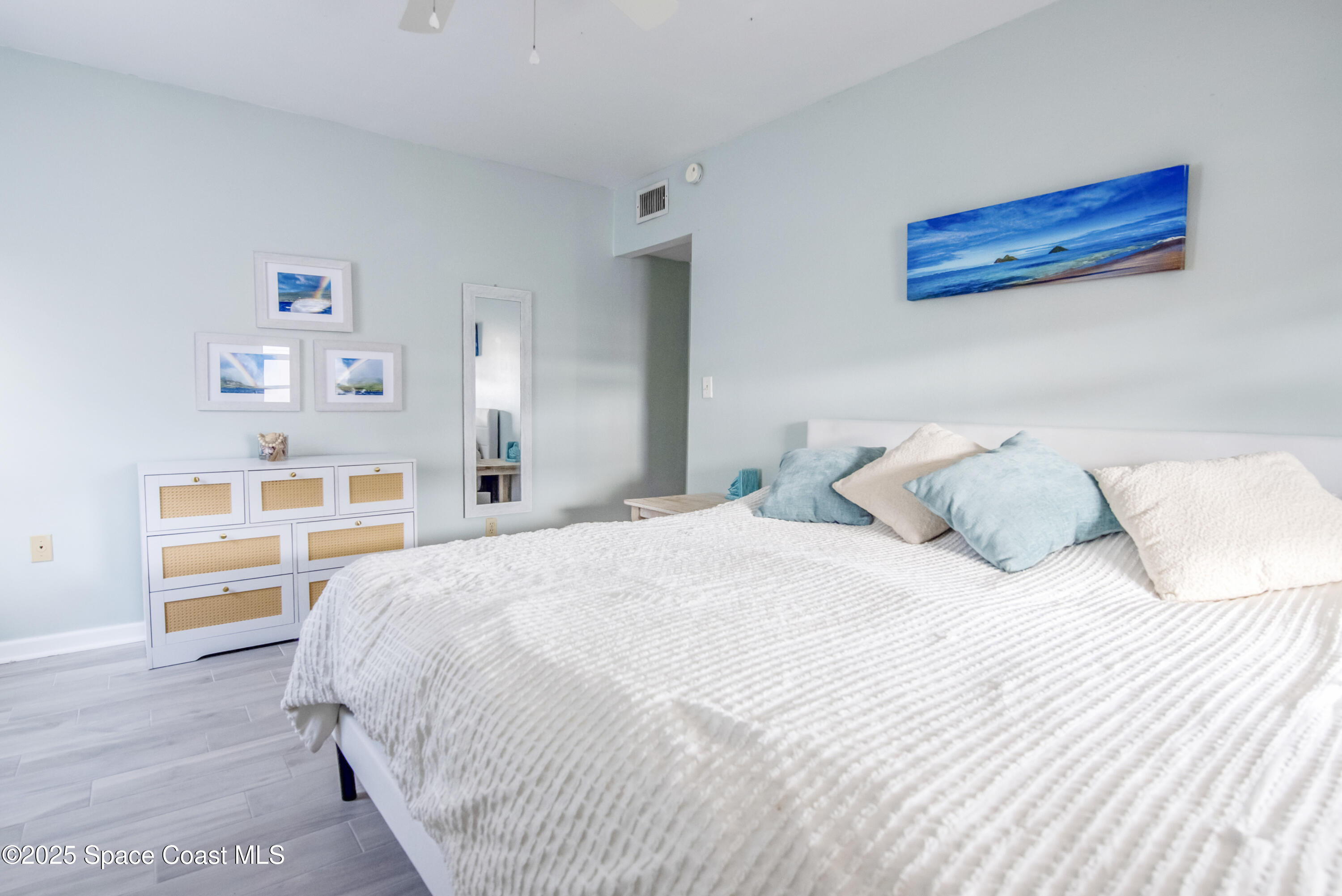 142 Atlantic Avenue Indialantic, FL 32903 - Photo 17 of 28 a bedroom with a bed and a cabinets