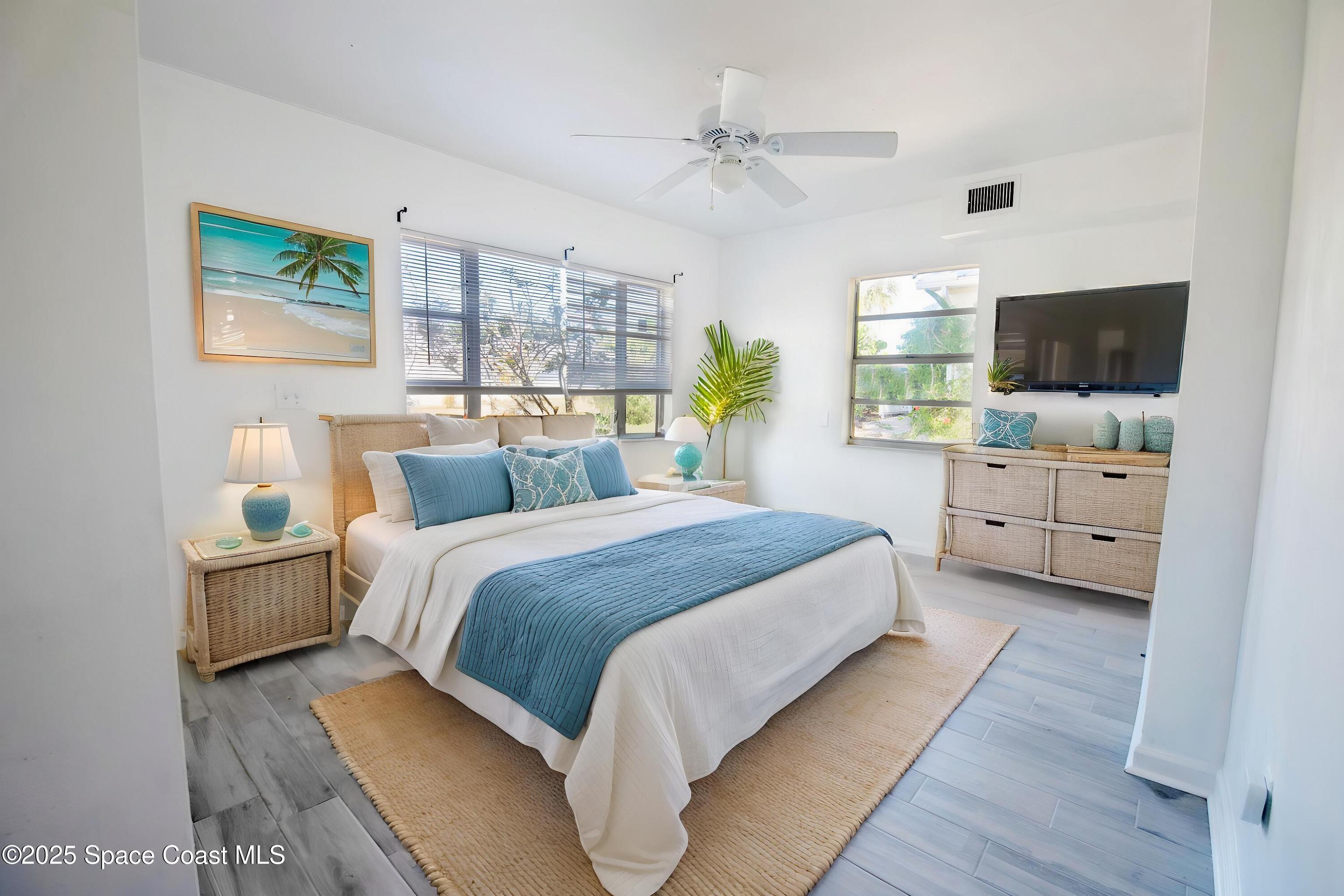 142 Atlantic Avenue Indialantic, FL 32903 - Photo 21 of 28 a bedroom with a bed and a flat screen tv