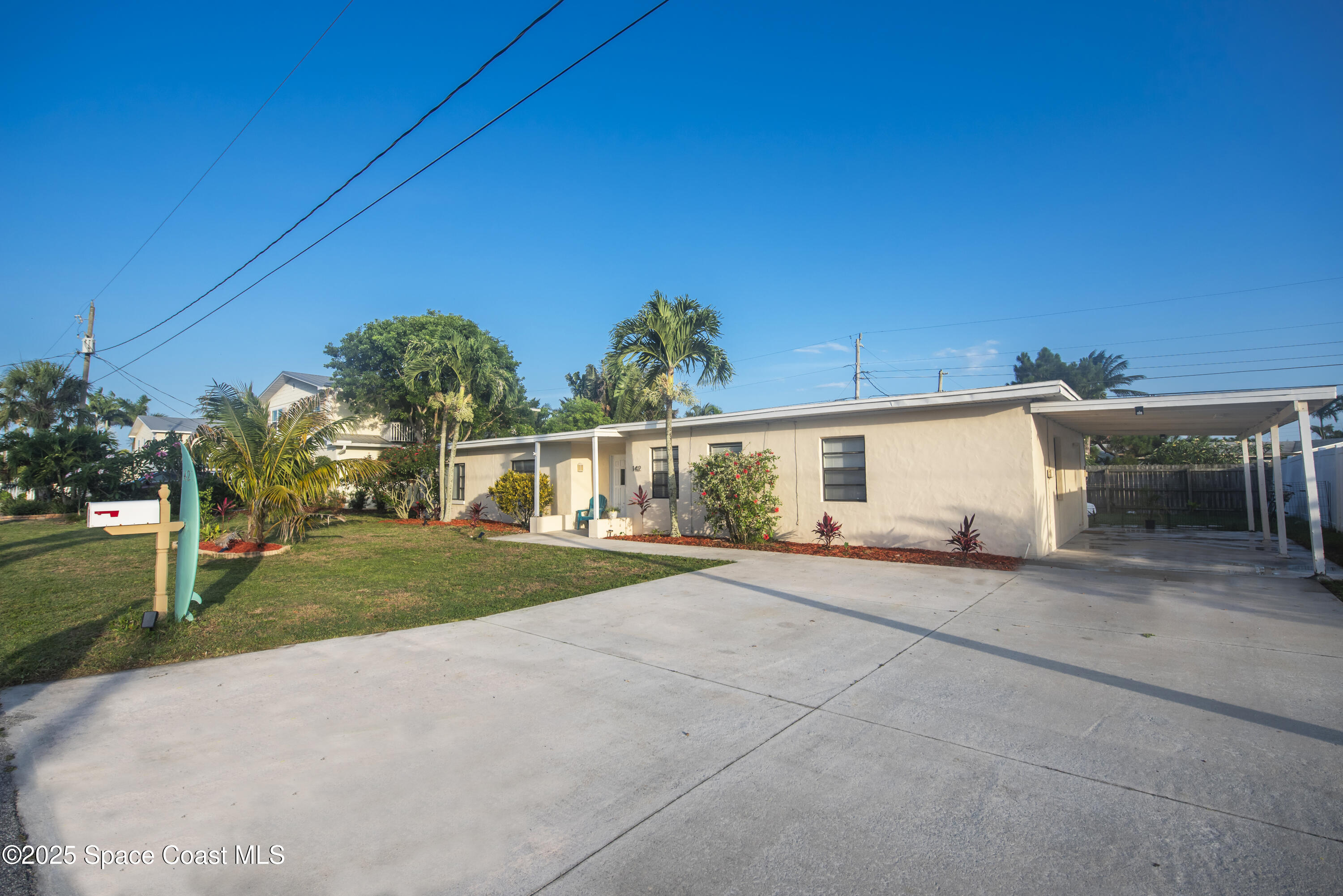 142 Atlantic Avenue Indialantic, FL 32903 - Photo 3 of 28 front view of a house with a yard and potted plants