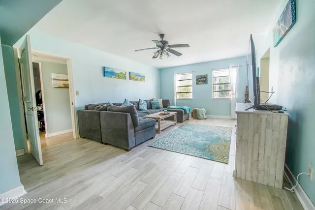 a living room with furniture window and wooden floor