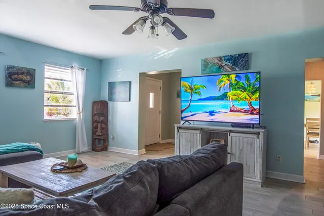 a living room with furniture and a dining table