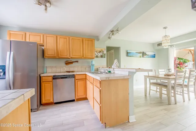 a kitchen with granite countertop a refrigerator stove top oven and sink