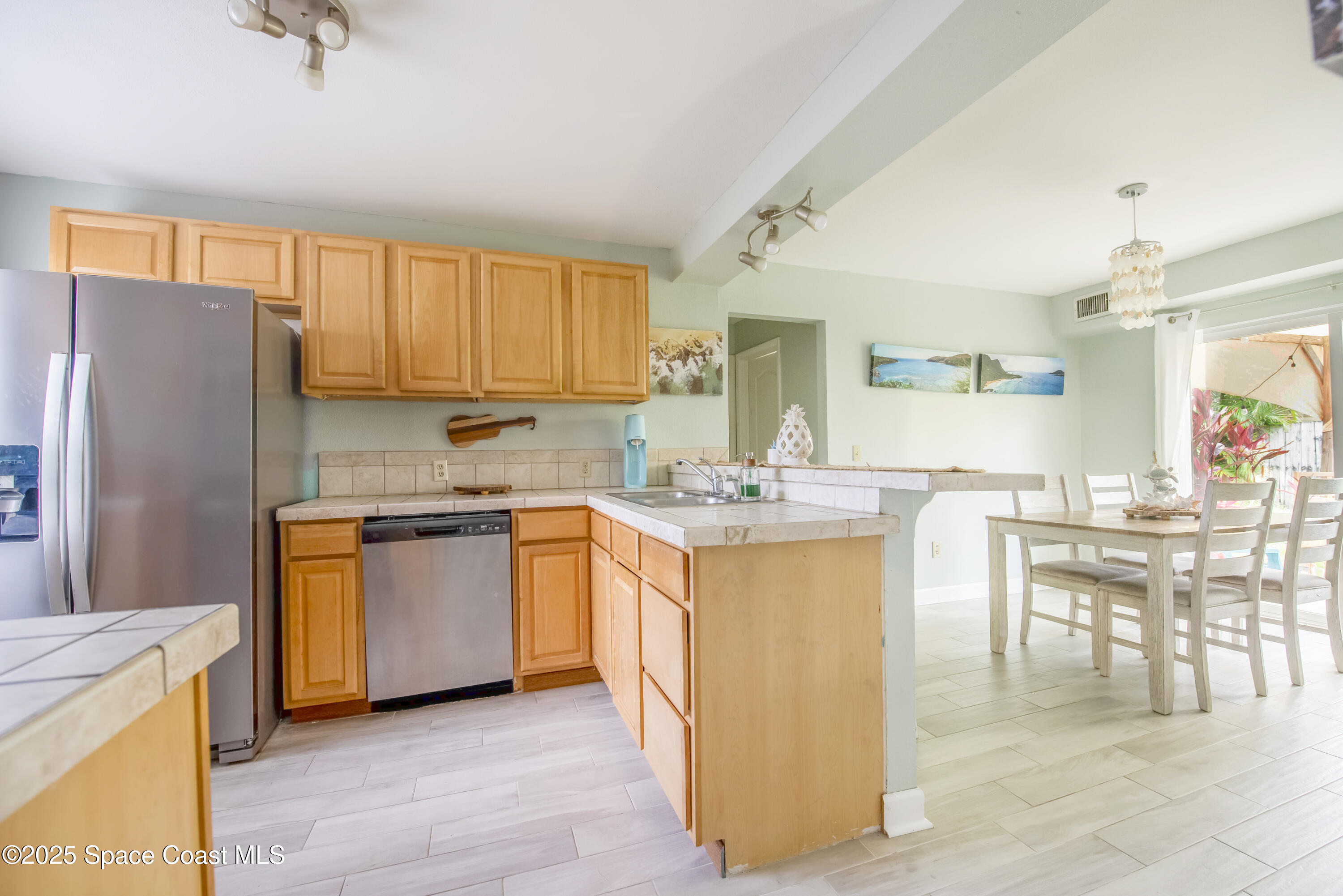 142 Atlantic Avenue Indialantic, FL 32903 - Photo 9 of 28 a kitchen with granite countertop a refrigerator stove top oven and sink