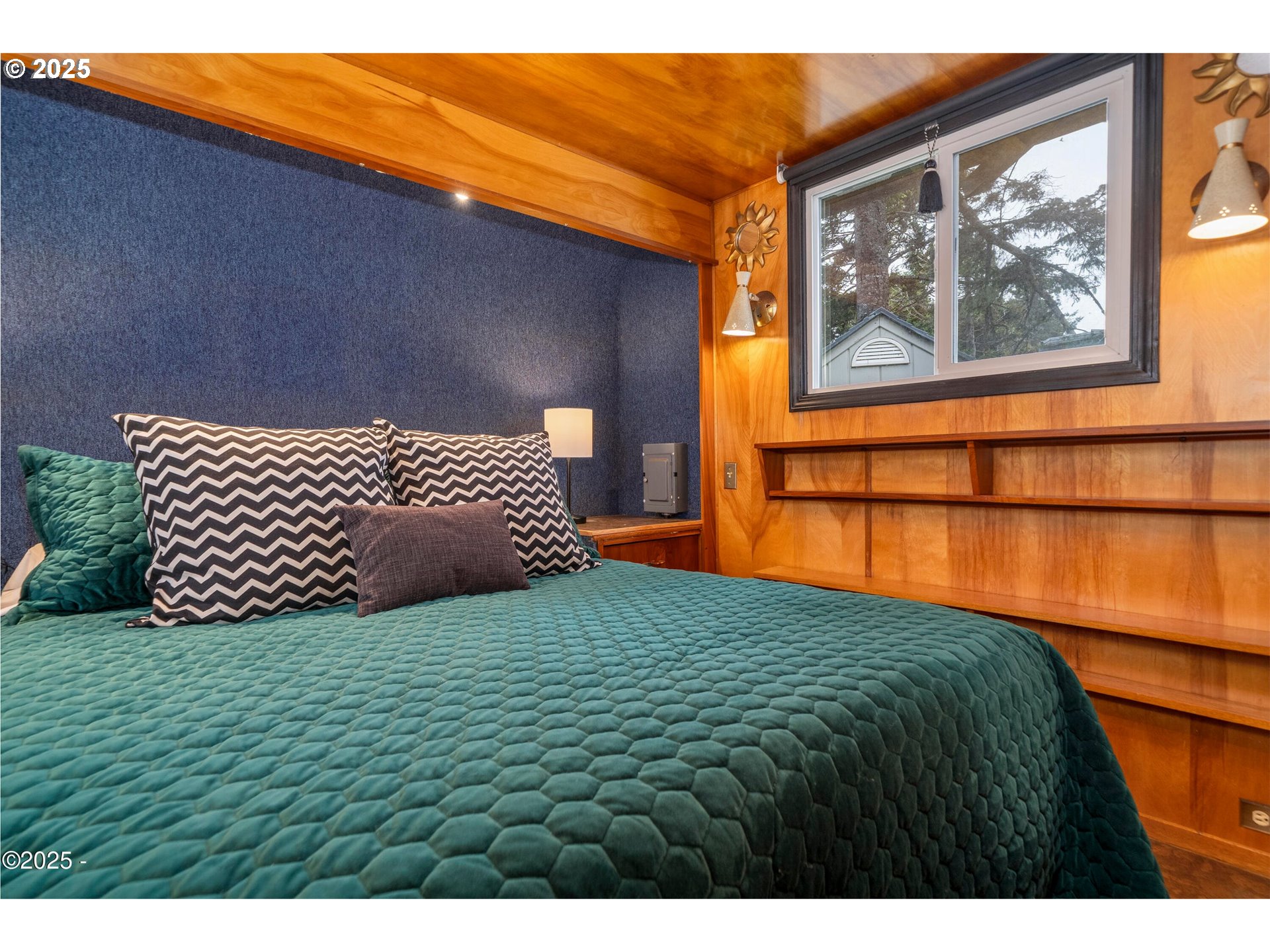 4875 Highway 101, Unit 11 Depoe Bay, OR 97341 - Photo 14 of 32 a bedroom with a bed and wooden floor