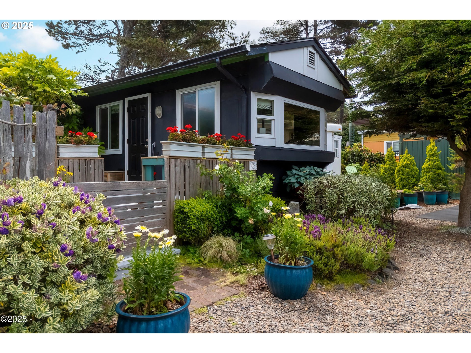 4875 Highway 101, Unit 11 Depoe Bay, OR 97341 - Photo 21 of 32 a view of a house with potted plants and a bench