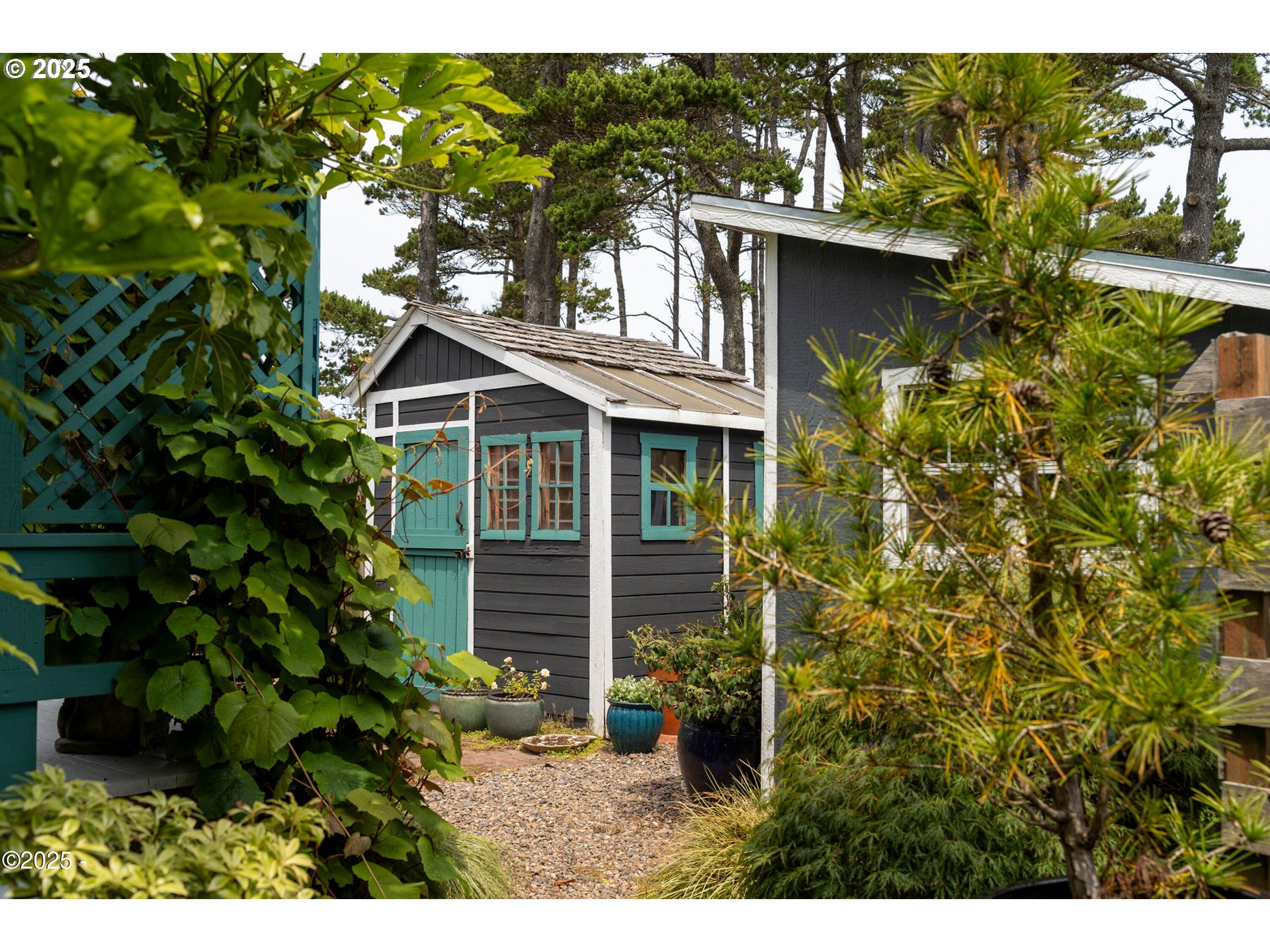 4875 Highway 101, Unit 11 Depoe Bay, OR 97341 - Photo 26 of 32 a yellow house with a yard and sitting area