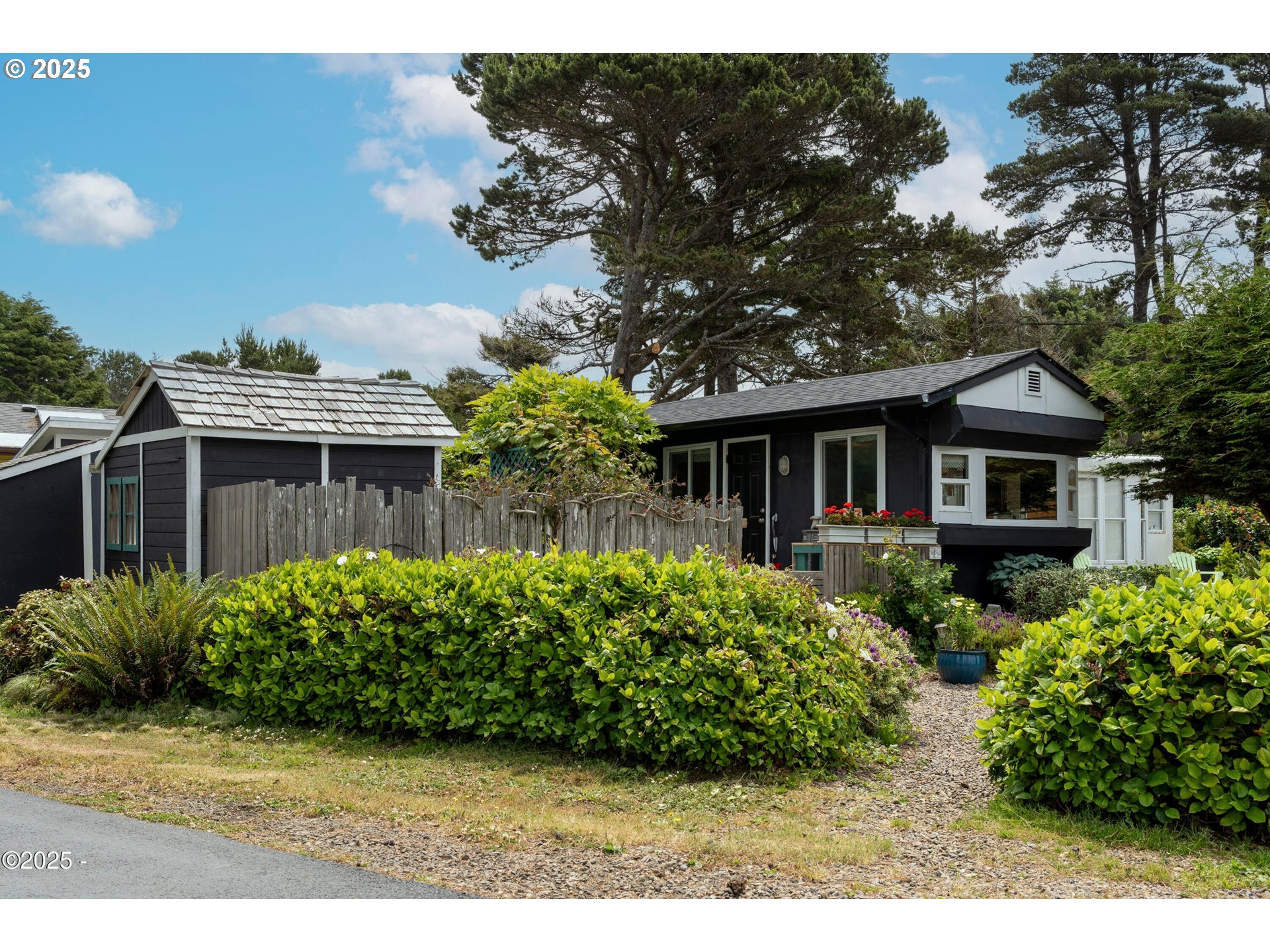 4875 Highway 101, Unit 11 Depoe Bay, OR 97341 - Photo 28 of 32 a front view of a house with a garden