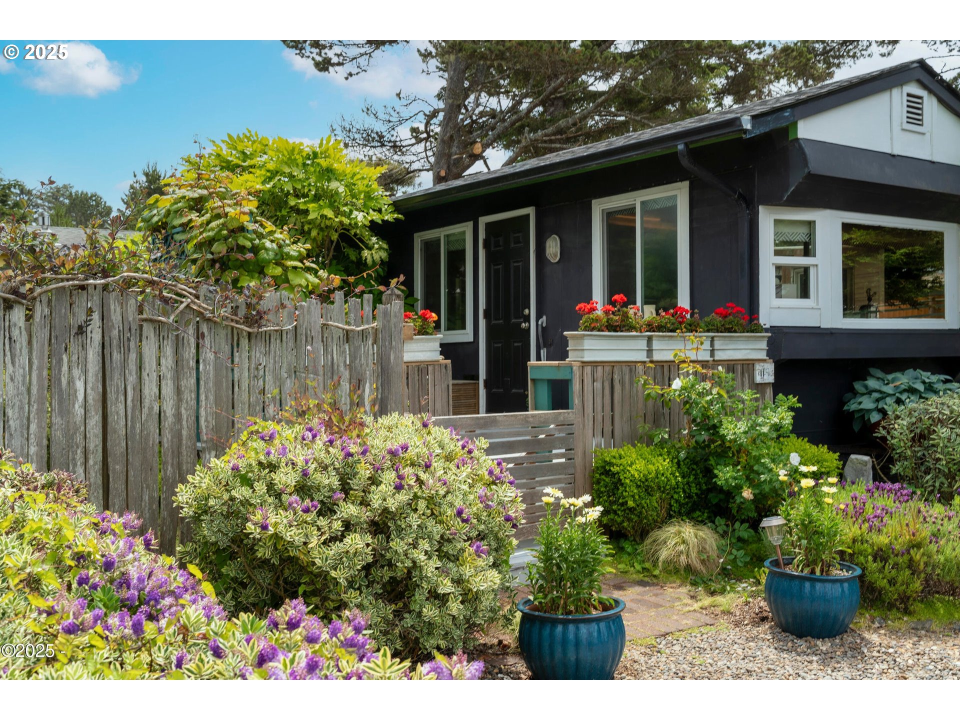 4875 Highway 101, Unit 11 Depoe Bay, OR 97341 - Photo 30 of 32 a view of a house with a flower garden