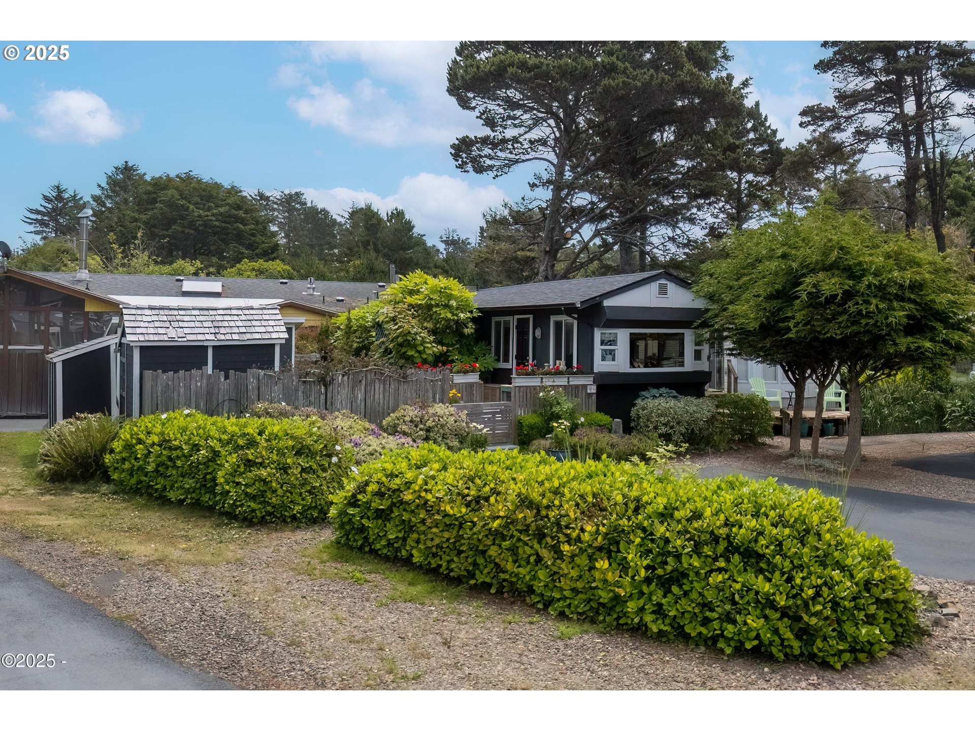 4875 Highway 101, Unit 11 Depoe Bay, OR 97341 - Photo 3 of 32 a front view of a house with a garden