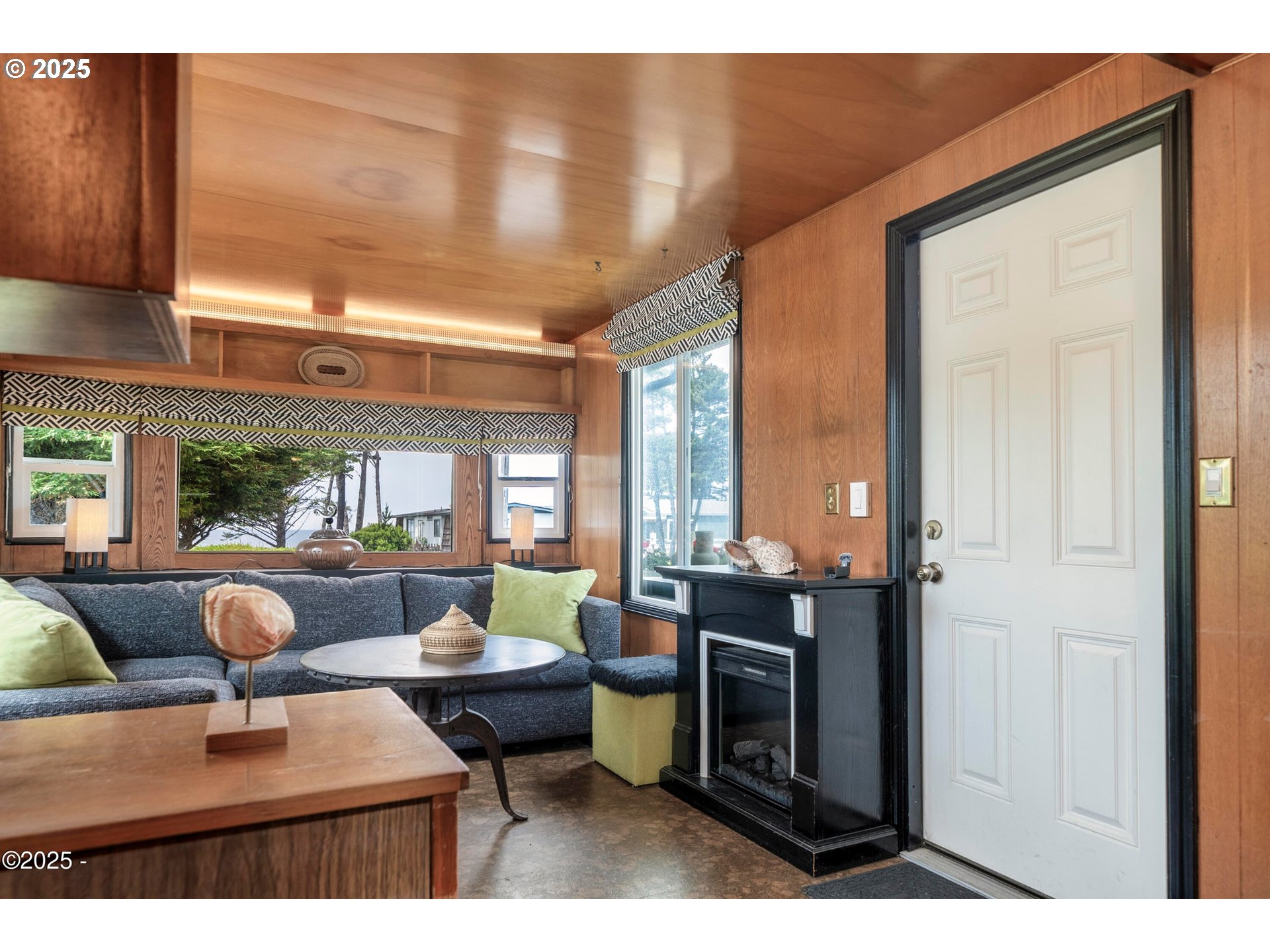 4875 Highway 101, Unit 11 Depoe Bay, OR 97341 - Photo 4 of 32 a living room with furniture a large window and flat screen tv