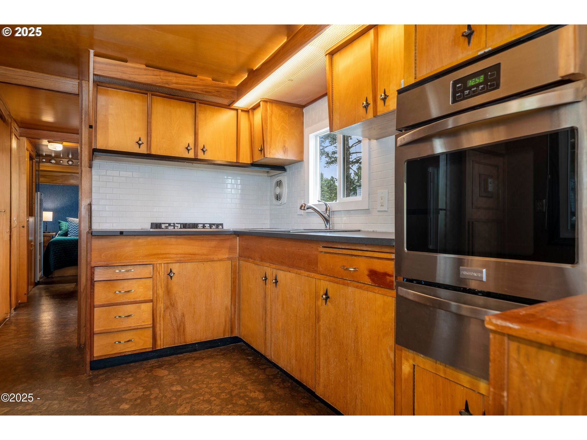 4875 Highway 101, Unit 11 Depoe Bay, OR 97341 - Photo 6 of 32 a kitchen with stainless steel appliances granite countertop a sink and cabinets