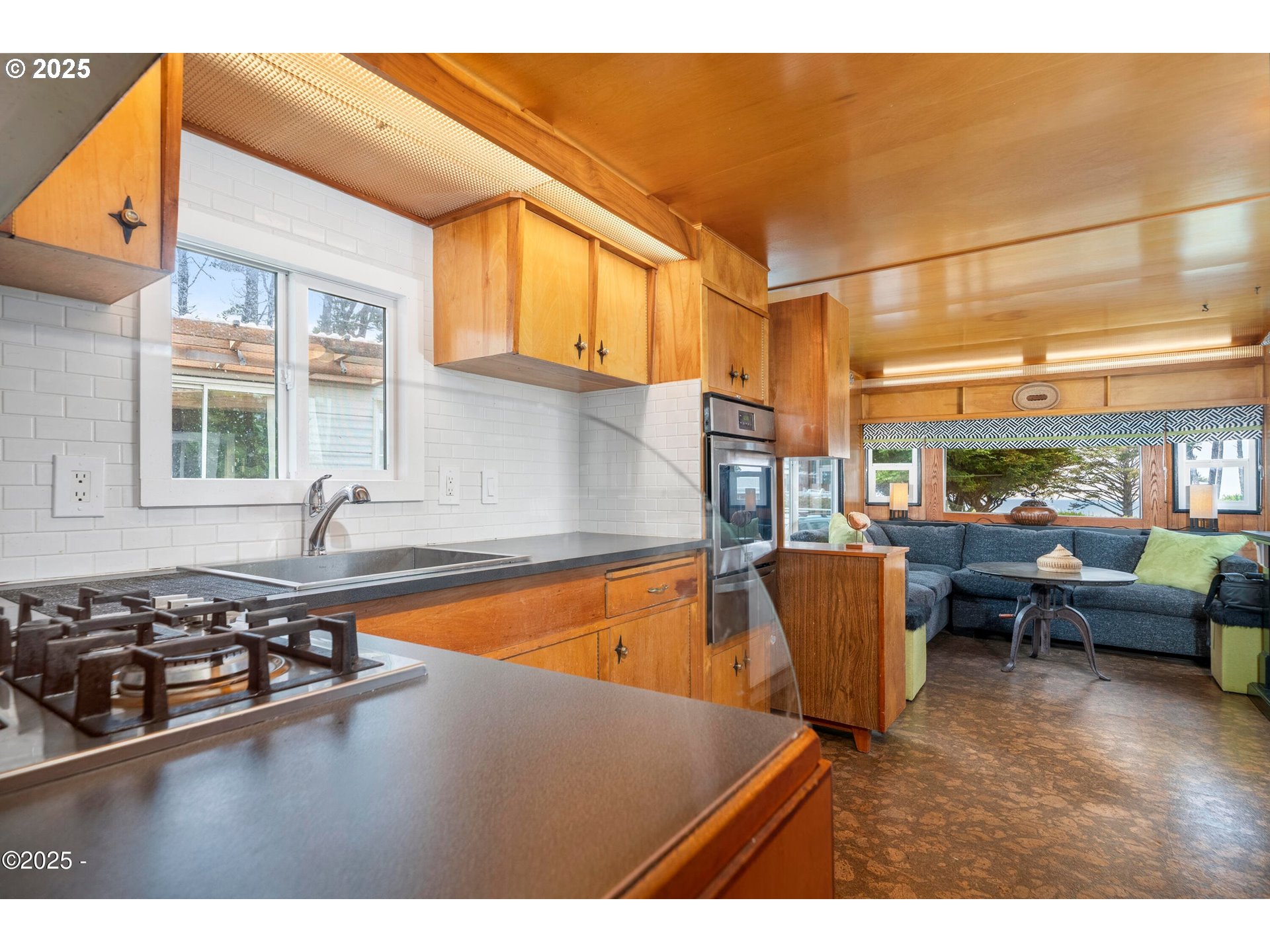 4875 Highway 101, Unit 11 Depoe Bay, OR 97341 - Photo 8 of 32 a living room with furniture a window and a dining table