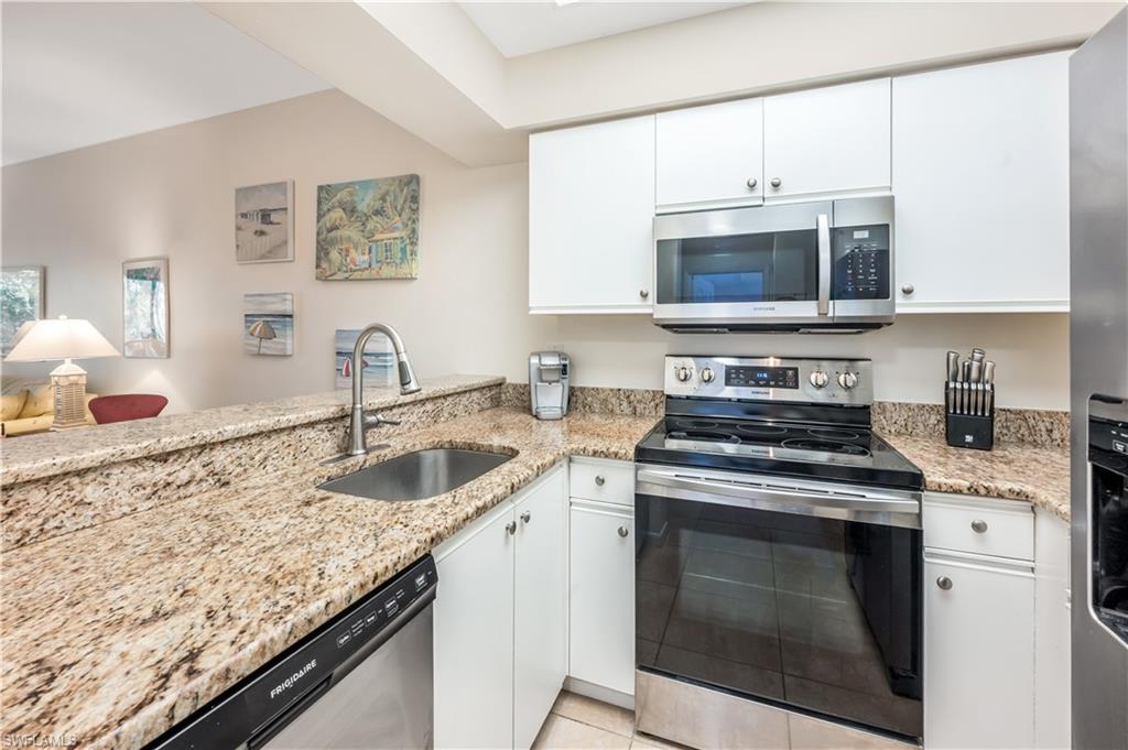 3321 Olympic Drive, Unit 623 Naples, FL 34105 - Photo 7 of 24 Open kitchen with breakfast bar