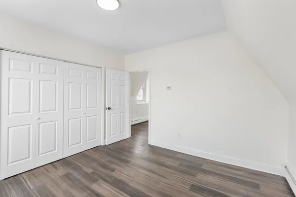 a view of an empty room and wooden floor